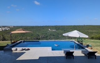 Austin pool tile and travertine coping — clean waterline and sealed edges